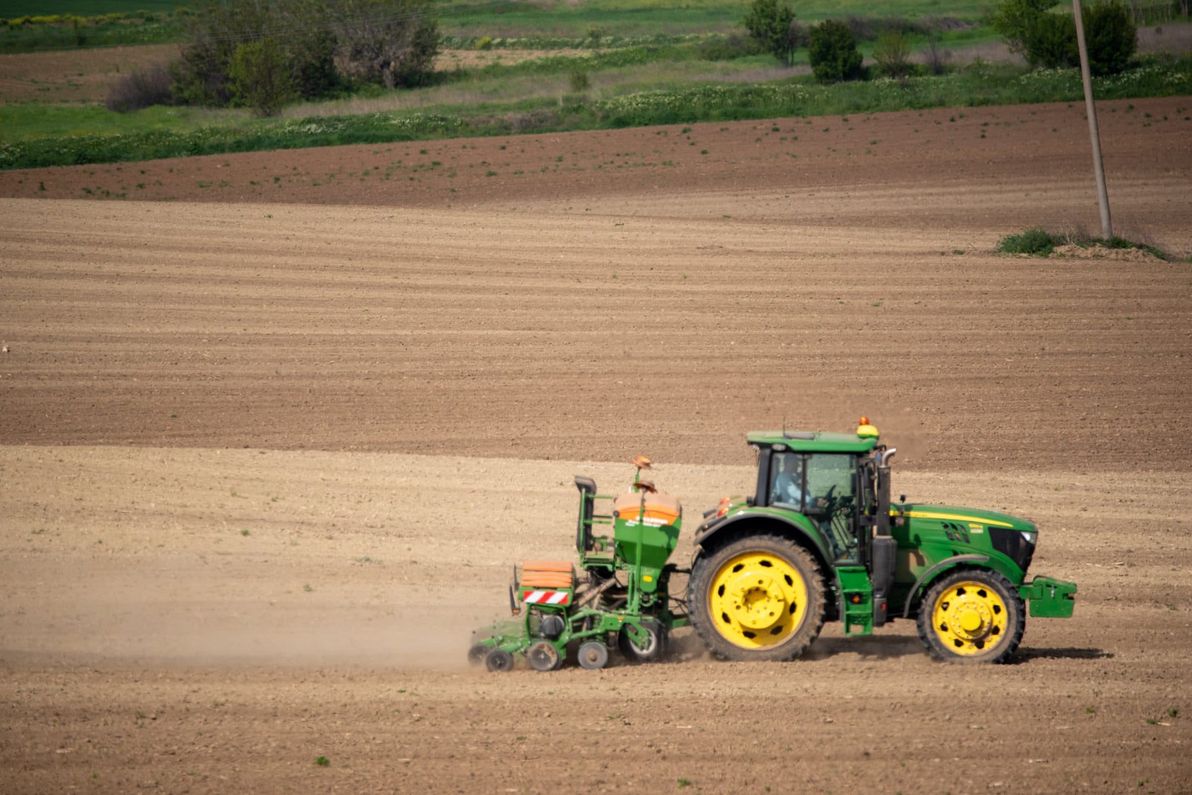 Tractor with a precision seed drill sowing a prepared field